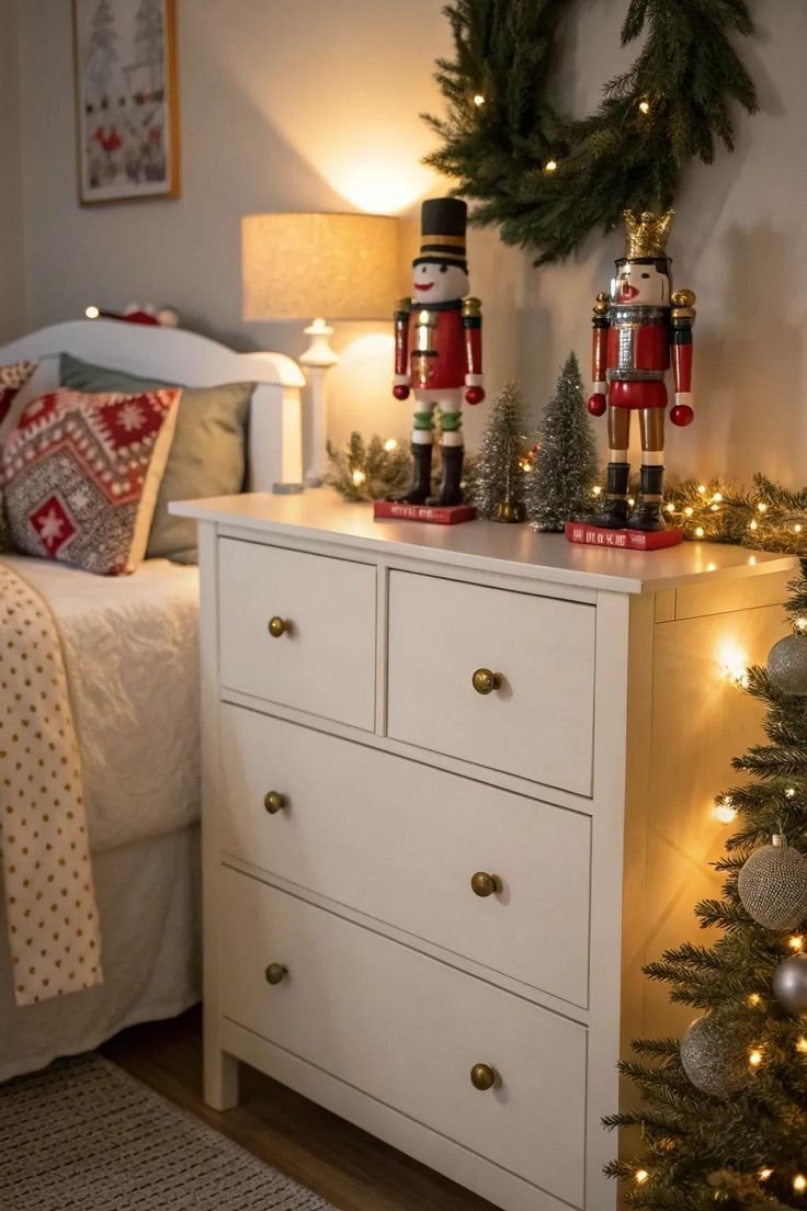 Wooden nutcracker figures and soft lights styled on a bedroom dresser