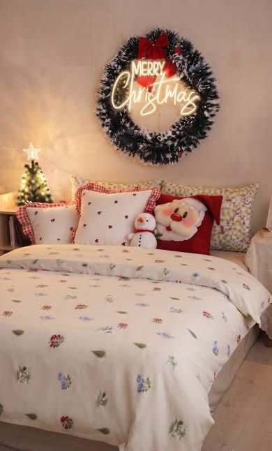 Small bedroom styled for Christmas with layered bedding and warm lighting