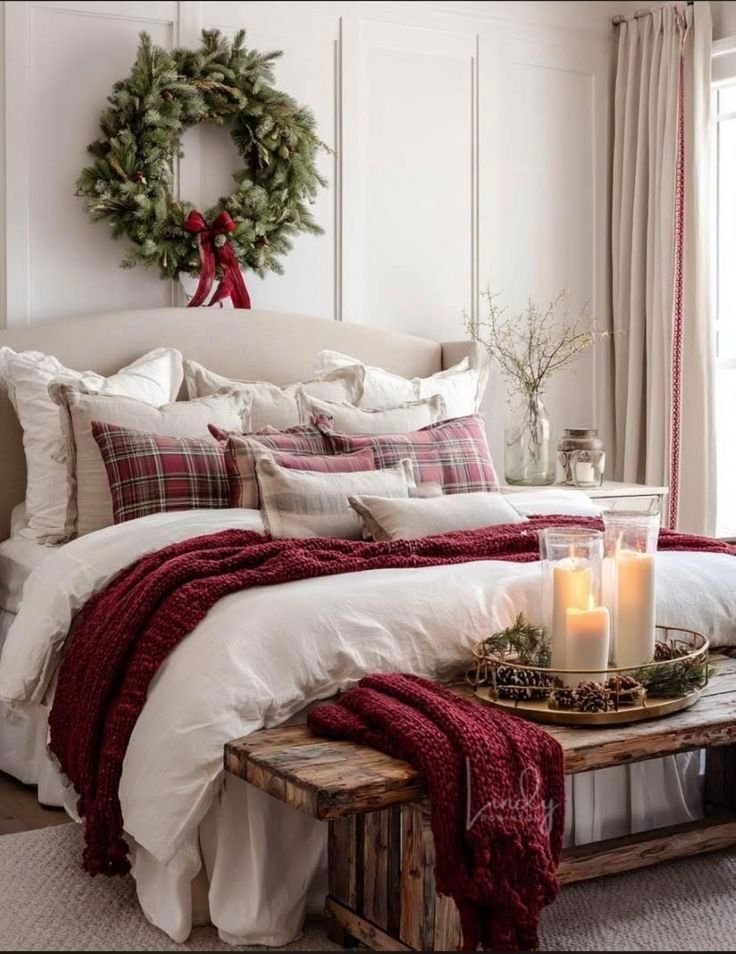 Evergreen wreath hung centered above a bed in a red and green Christmas bedroom