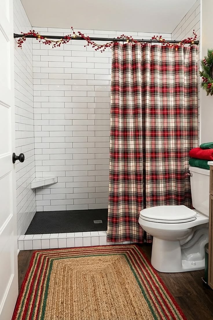 Red plaid Christmas shower curtain with a berry garland draped on the rod