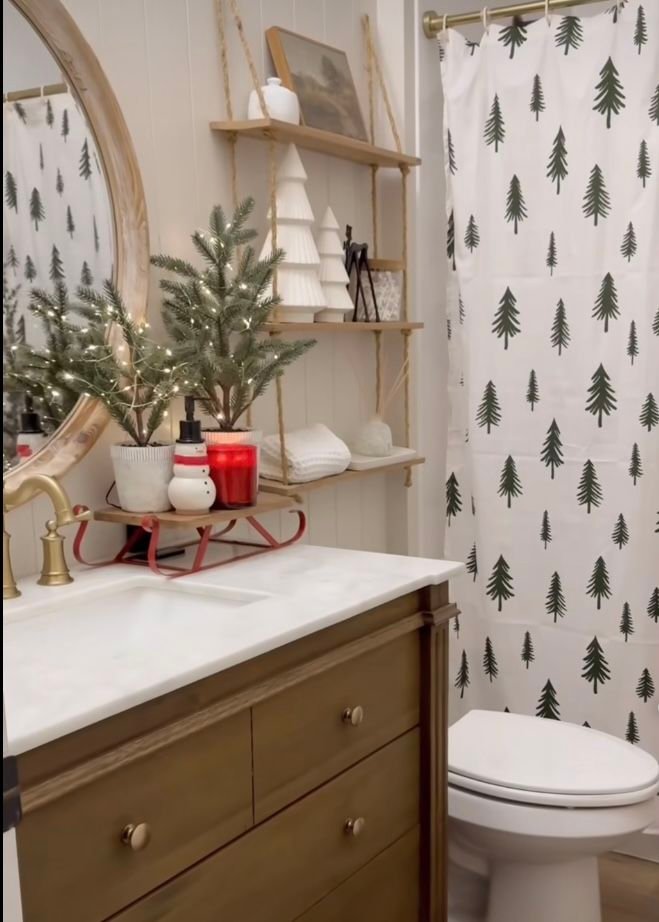 Pine tree print shower curtain with a styled sled tray on the vanity