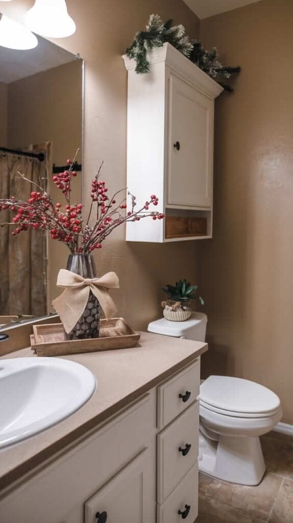 Berry branch vase on a cabinet mounted above a bathroom toilet