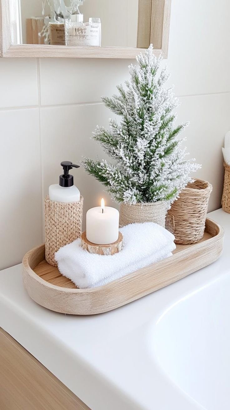 Flocked Christmas tree with a lit candle on a wooden bathroom tray
