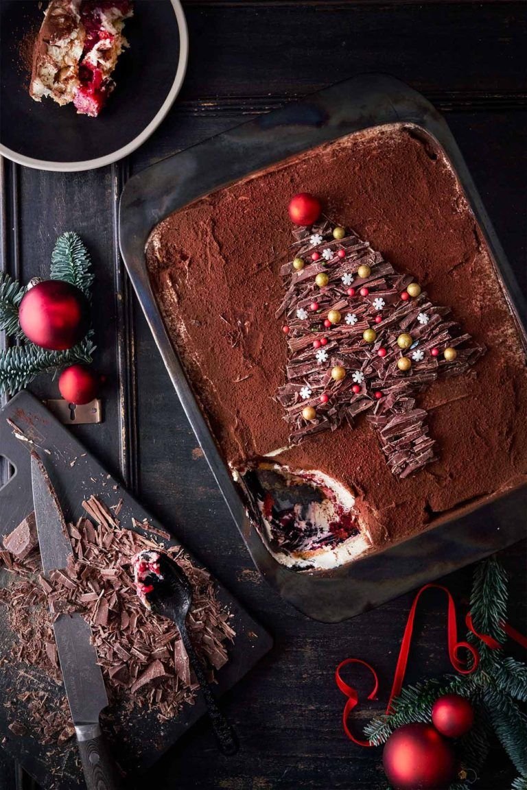 A chocolate tiramisu dusted with cocoa and decorated with a chocolate shaving Christmas tree