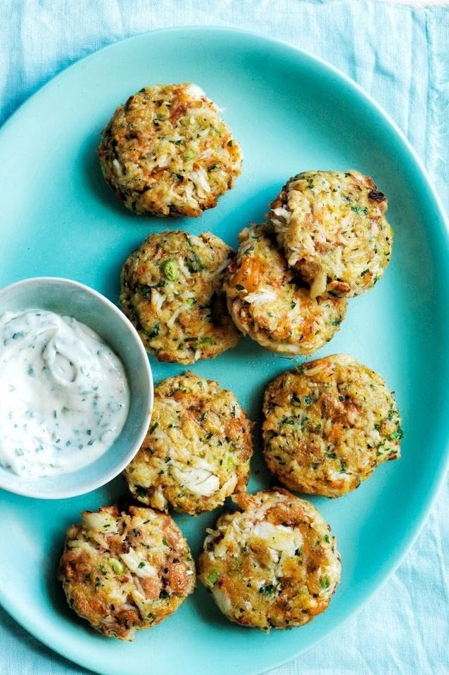 Mini crab cakes served with a bowl of herbed aioli
