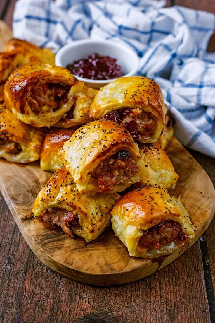 Mini sausage rolls with poppy seed topping and cranberry dipping sauce