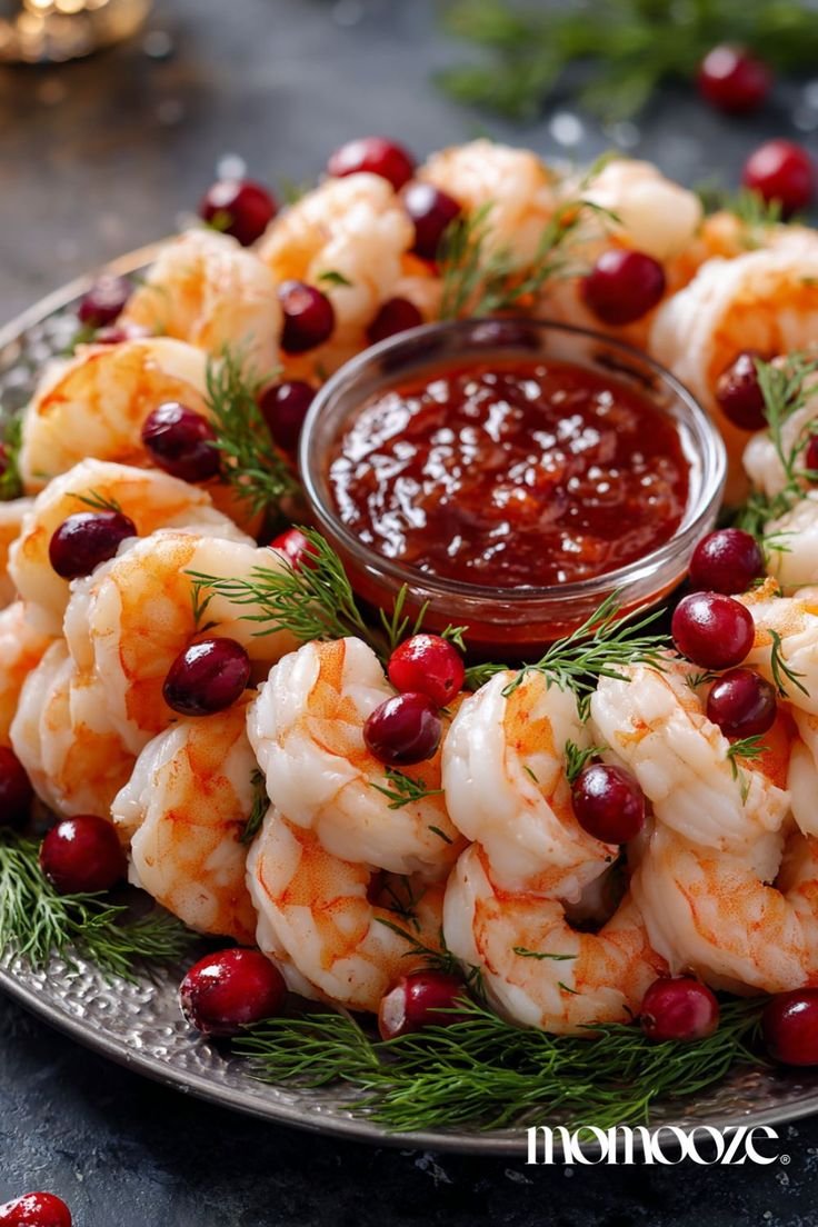 Shrimp cocktail arranged in a wreath shape with cranberries and cocktail sauce