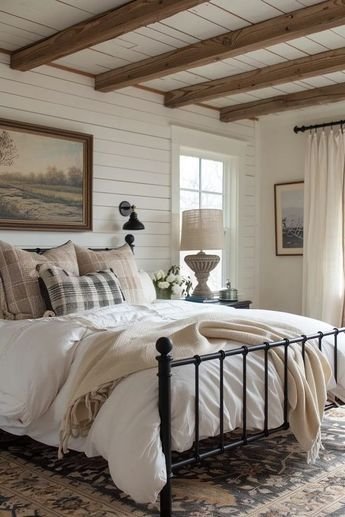 Cottagecore bedroom with white shiplap walls and an exposed dark wood ceiling beam