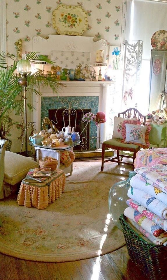 Stack of folded vintage patchwork quilts in a cottage-style interior