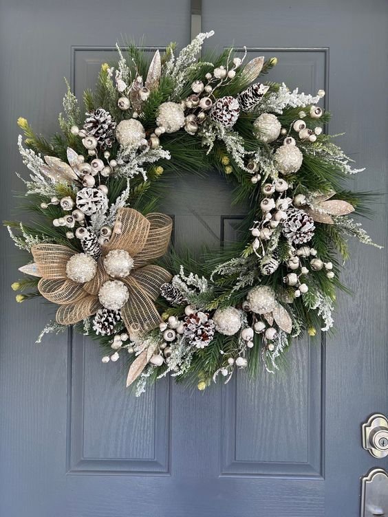 White and silver Christmas wreath with a burlap mesh bow