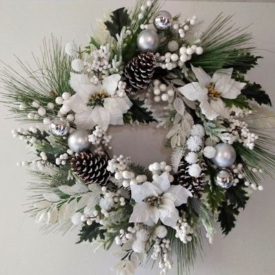 White and silver Christmas wreath with poinsettias and ornaments