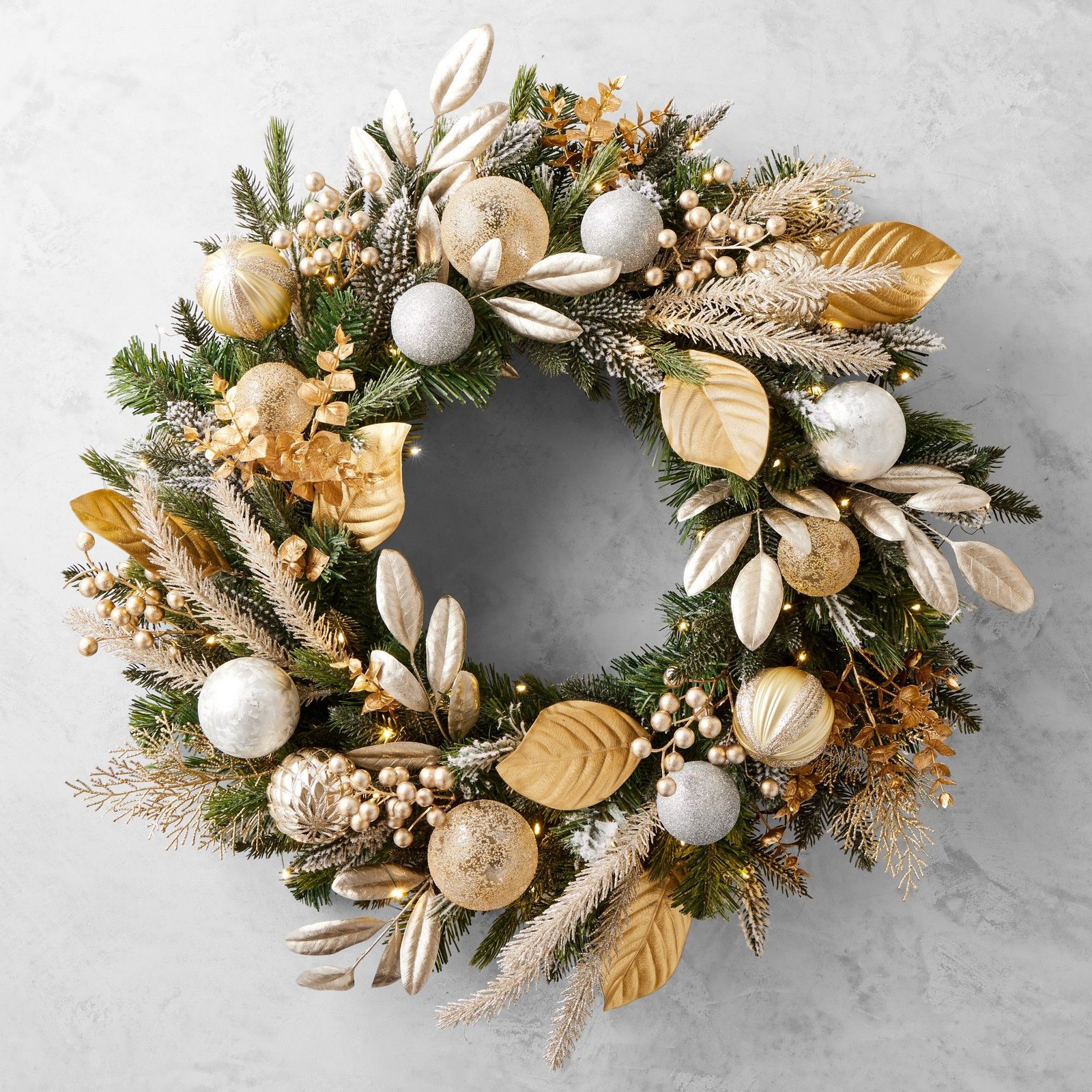 Gilded champagne ornament wreath with gold leaves and string lights