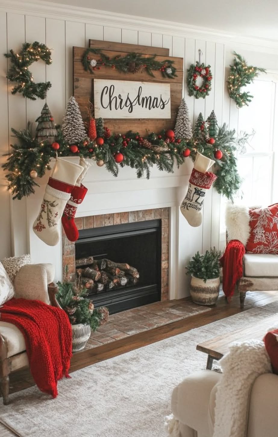 Red and green Christmas mantel with a wooden Christmas sign, stockings, and bottle brush trees