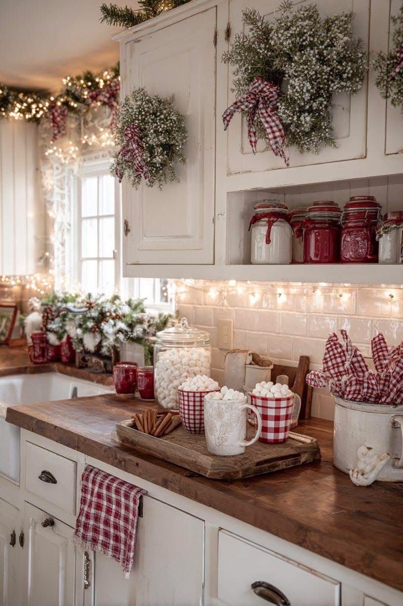 A tiered rack with Santa face mugs, candy canes, and a Coal dish