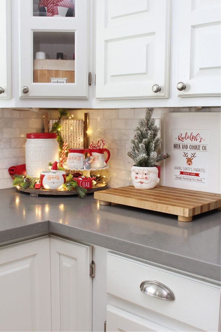 Baby's breath wreaths tied with plaid bows hanging on upper kitchen cabinets