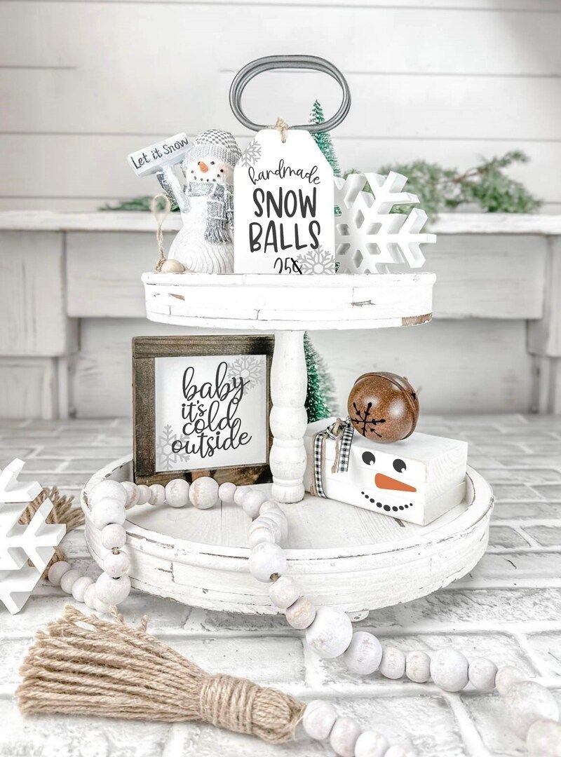 Tiered tray with a handmade Snow Balls 25 cents sign and wood bead garland