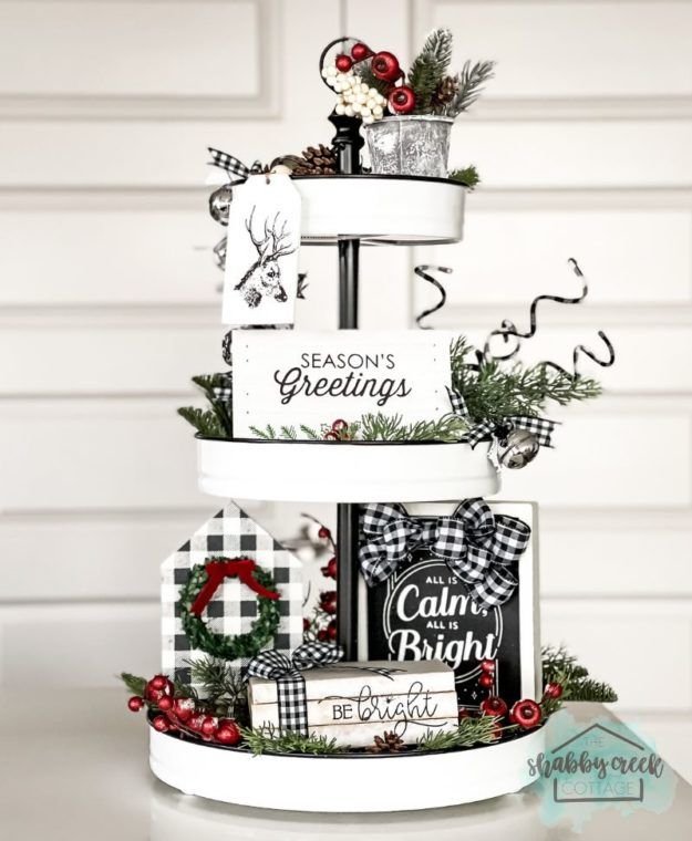 Tiered tray with a Seasons Greetings sign and black and white buffalo plaid decor