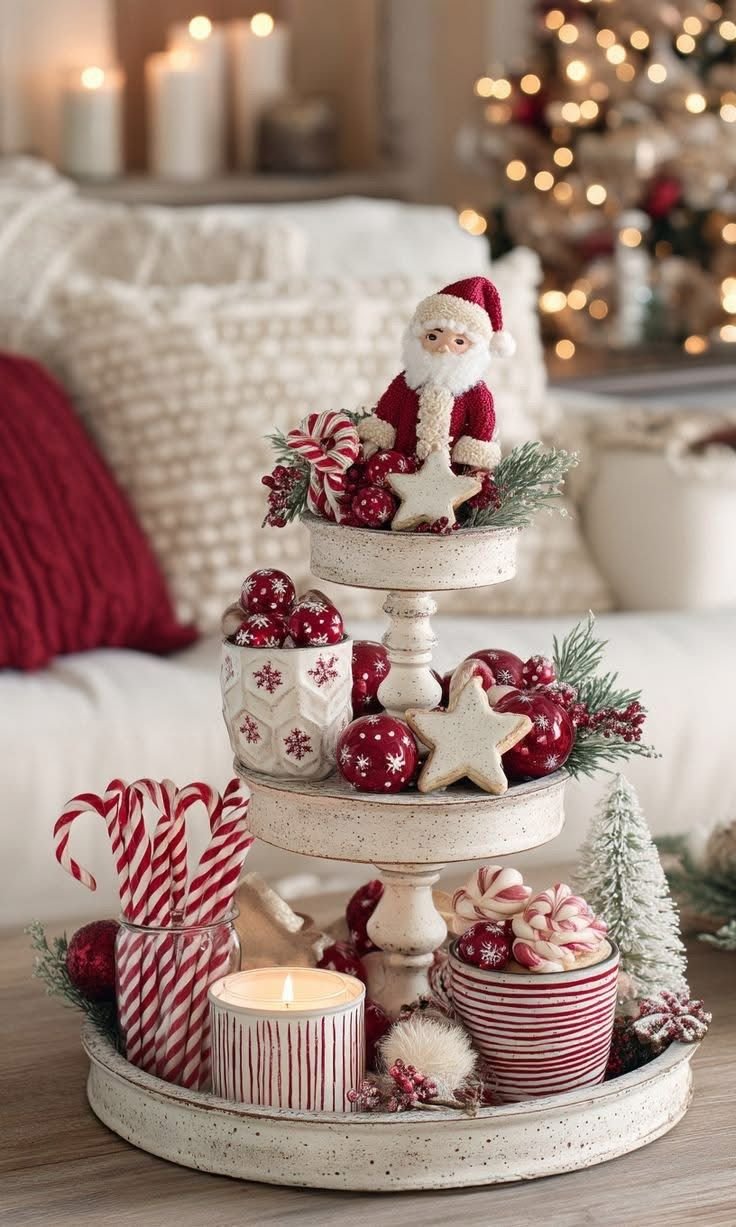 Three-tier white Christmas tray with a Santa figurine, ornaments, and star cookies