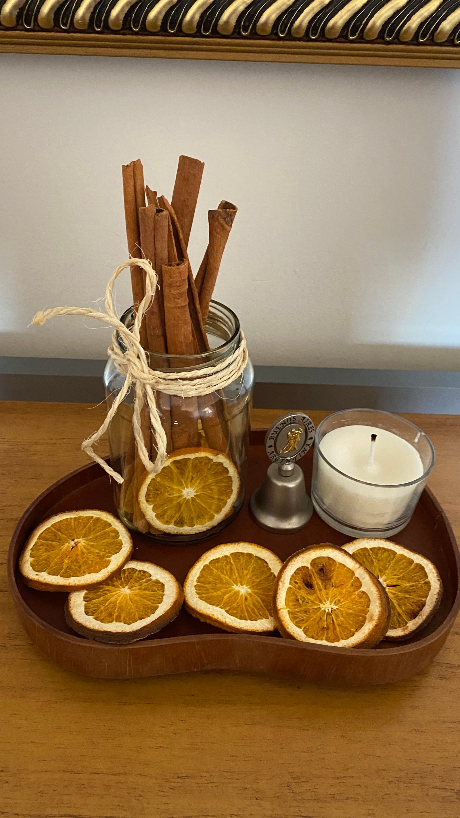 Wood slice tray with dried orange slices and a cinnamon bundle