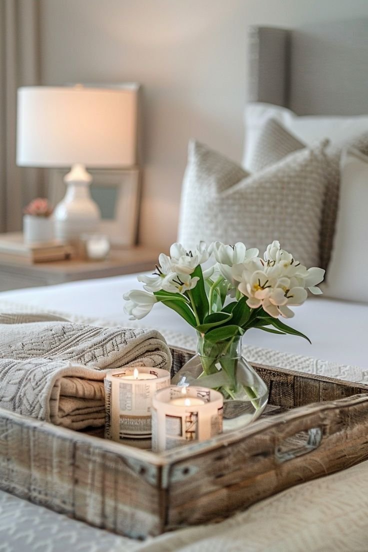 Bedroom tray with white tulips and rolled candles in newspaper wraps