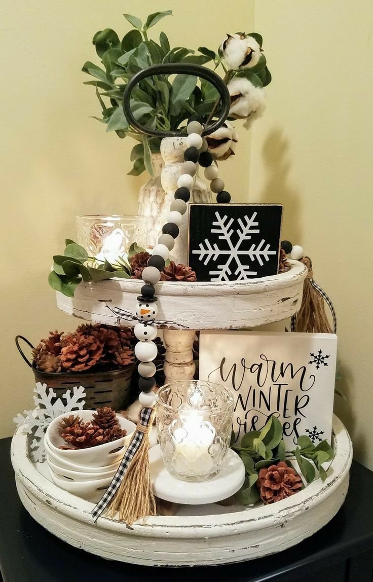 Tiered tray with cotton stems and a wooden snowflake sign