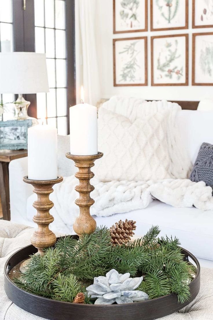 Black tray with turned wood candlesticks and pine greenery