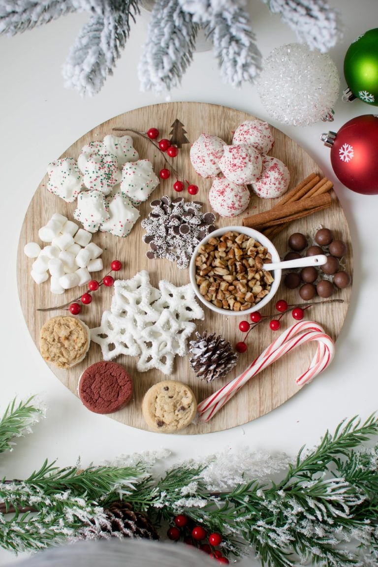 Round tray filled with Christmas cookies, bark, and candy canes