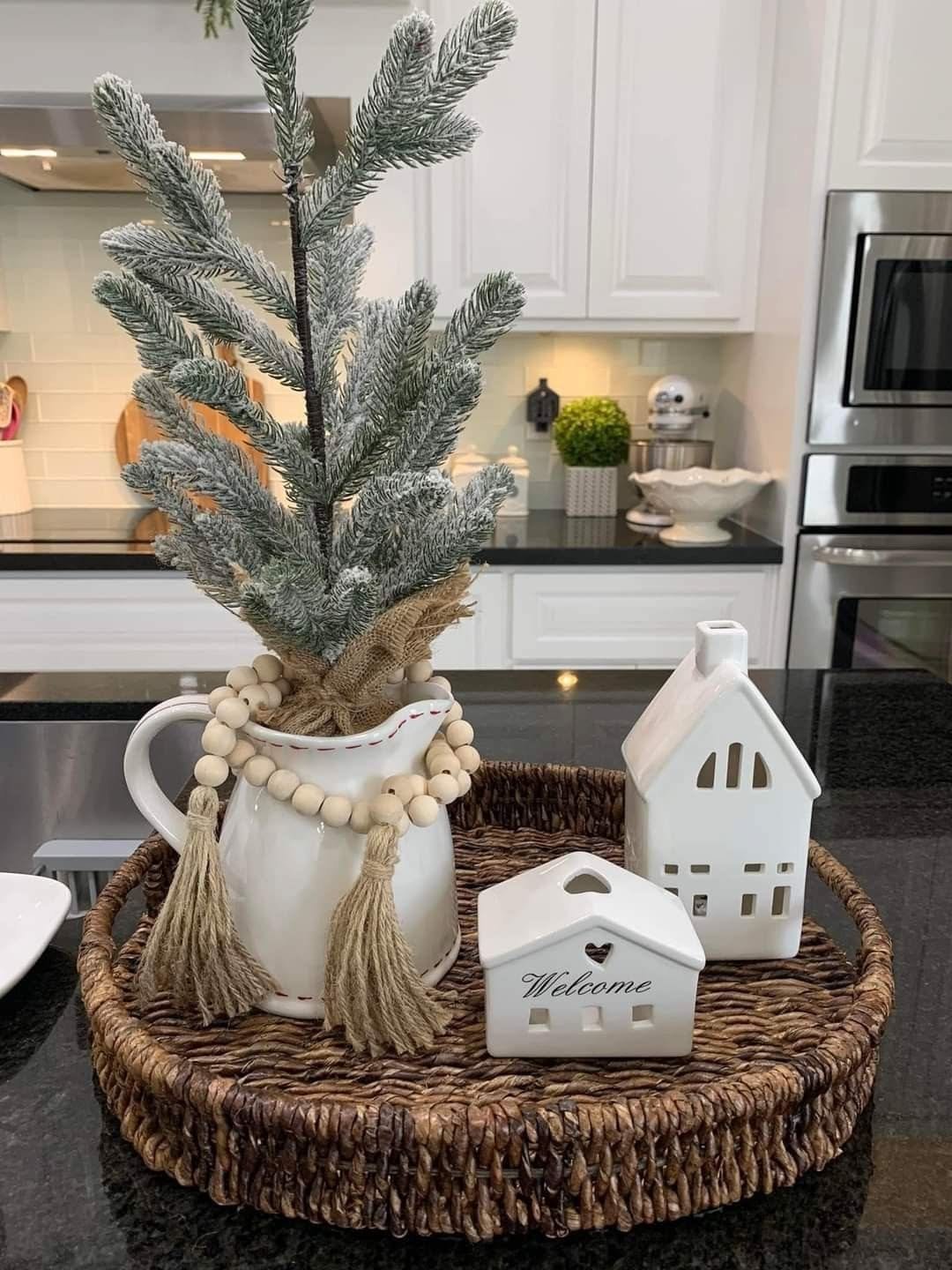 Woven tray with a wood bead garland and a white ceramic pitcher